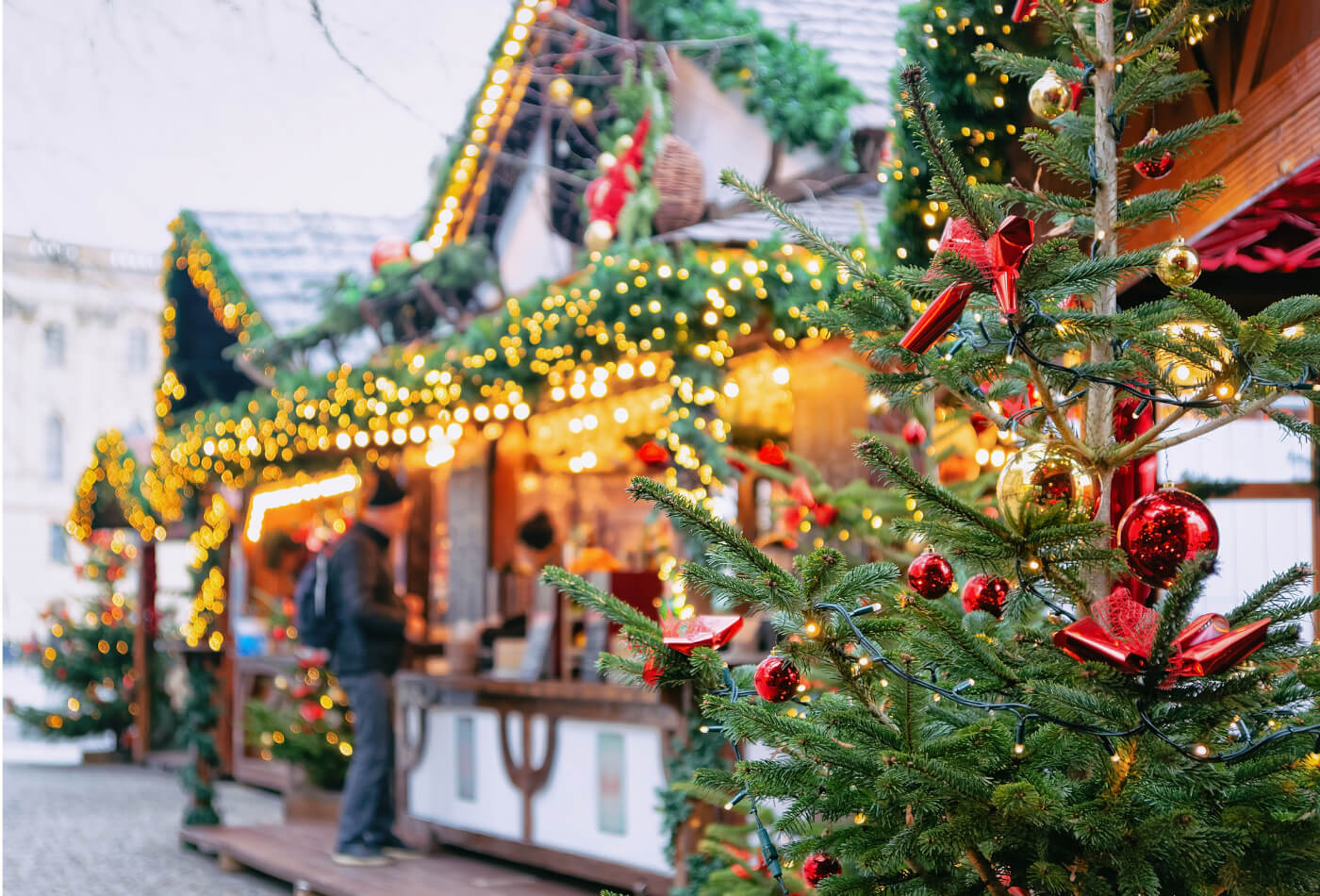 A Christmas market in Cornwall with a Christmas tree in the foreground.
