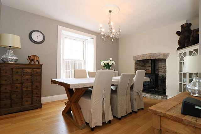 Penlaurel holiday cottage dining room - bear theme throughout the house. Dining table with open fireplace and woodburner.