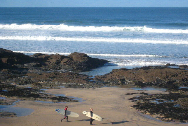 surfers on gwithian towans beach