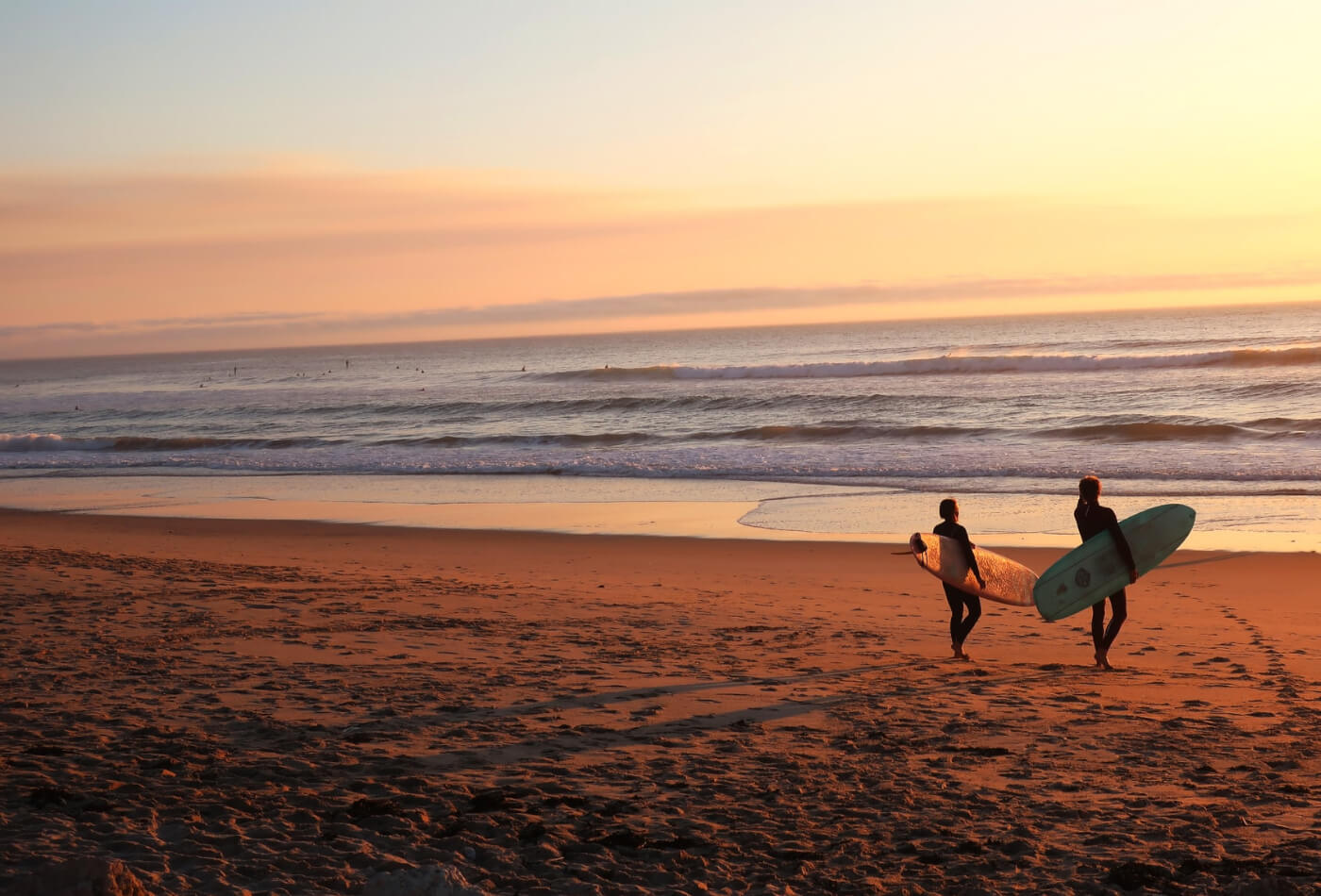 two surfers on beach