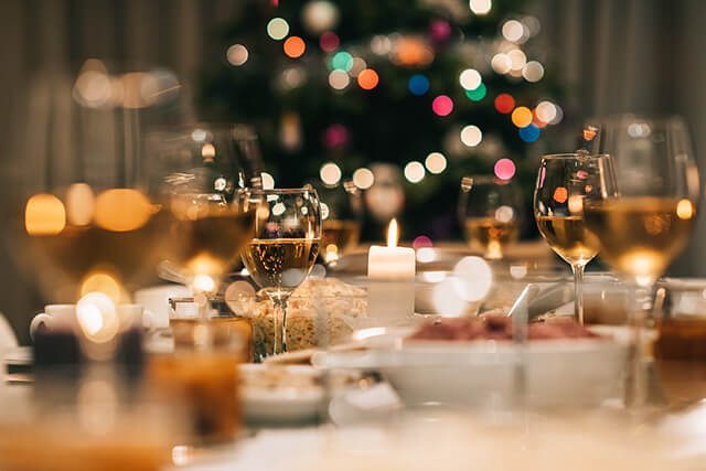 christmas dinner table with crockery and glassware