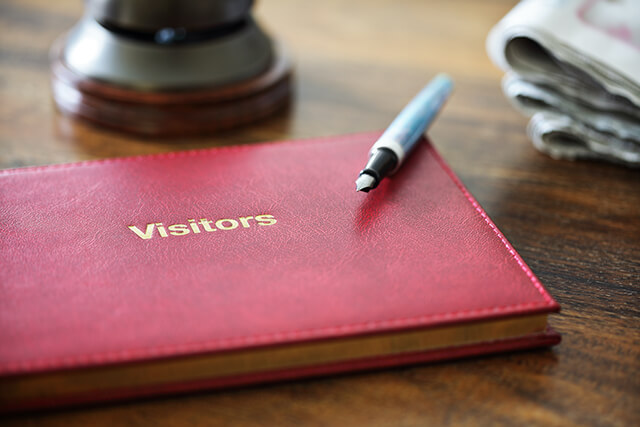 guest book on table with a pen 