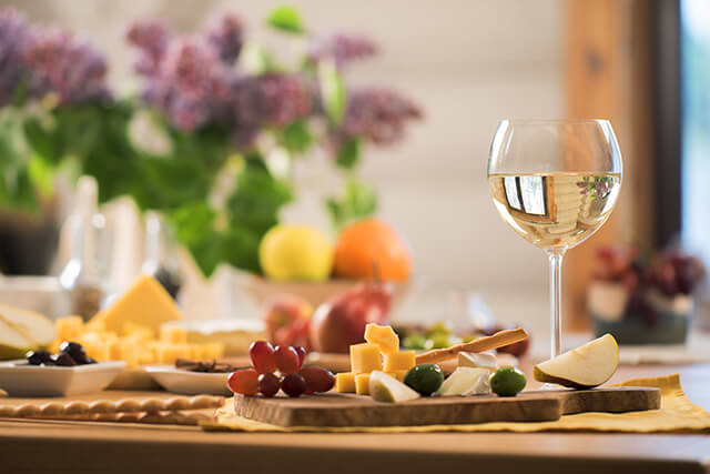 Wine and cheese on table in holiday home