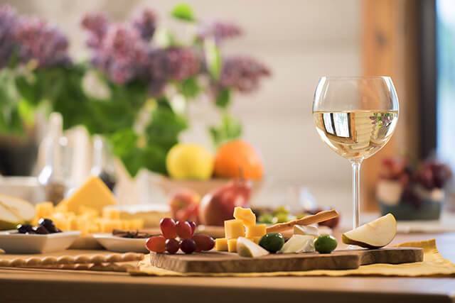 Wine and cheese on table in holiday home