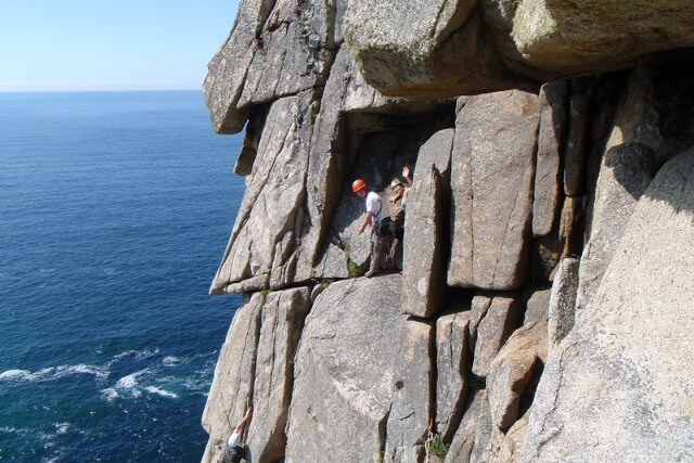 Climbers rock climbing in Cornwall on route Doorpost at Bosigran.
