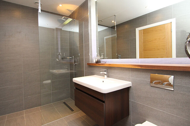 modern bathroom with economical shower, sink and toilet.