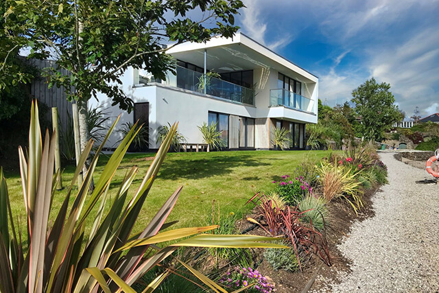 exterior of Ancarva in Kingsands with lush green garden.