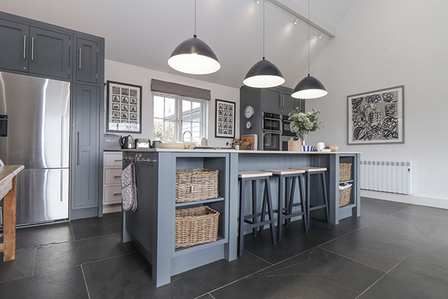 Modern kitchen with island and appliances.