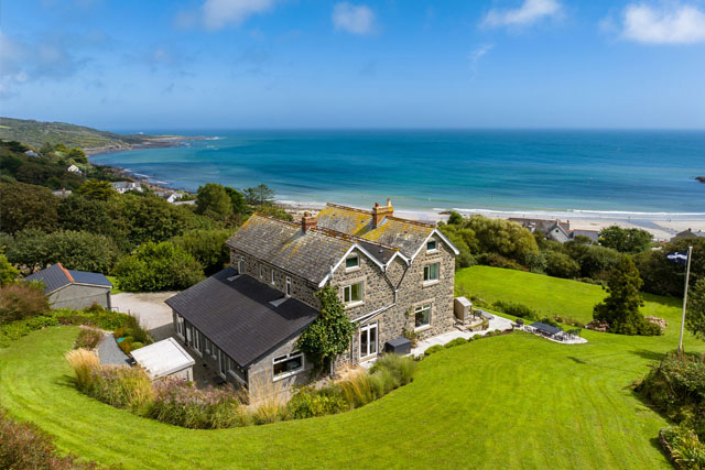 Aerial view of Penmarth House, Coverack and the sea behind
