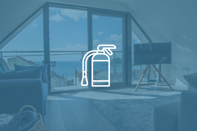 Fire extinguisher icon overlaid on an interior shot of a Cornish Cottage Holidays property