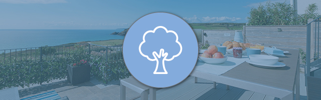 A sea view from a holiday cottage, overlaid with a tree icon representing sustainability.