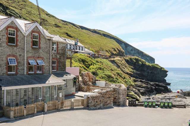 Holiday home in a small Cornish cove, looking towards a beach, sea and cliffs in the background