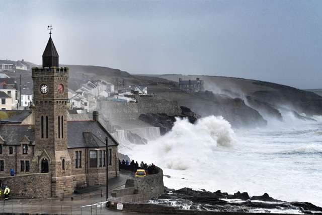 Waves crashing against harbour wall during a storm in Porthleven, Cornwall