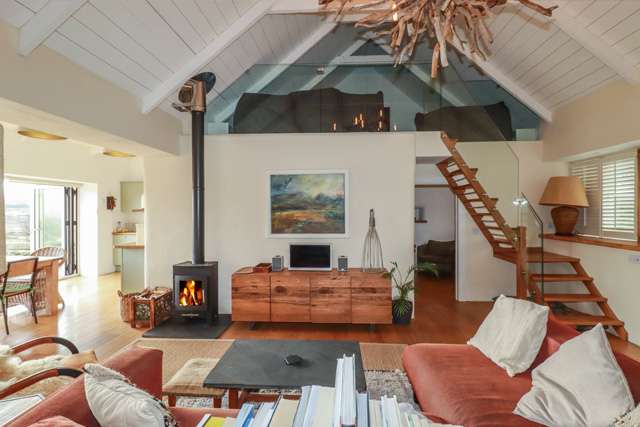 Large open plan lounge in a barn conversion, with a mezzanine floor above